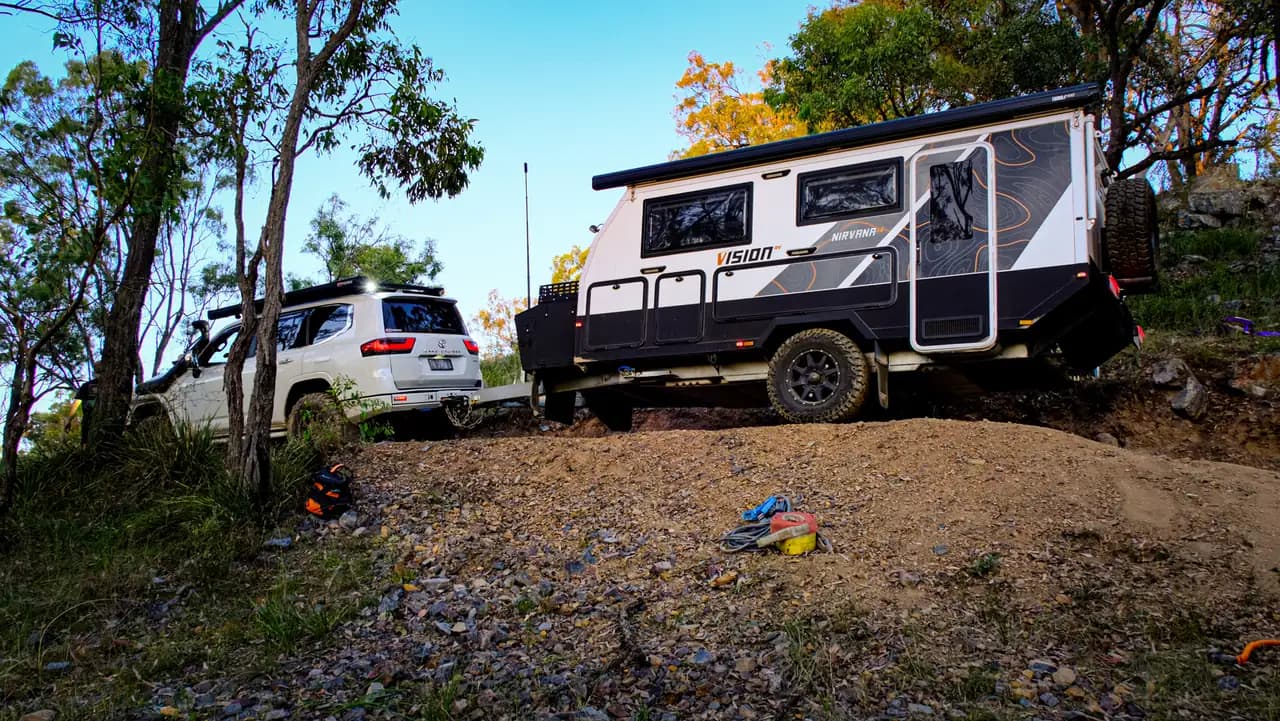 Vision RV Nirvana 14 towed up a rocky climb by a LandCruiser at The Springs 4x4